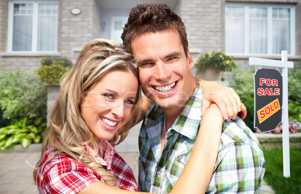 Happy couple near new house. Stock photo © Kurhan