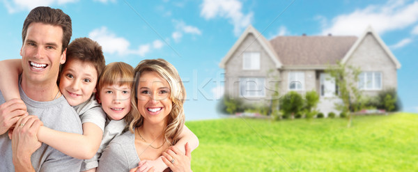 Stock photo: Happy family near new house.