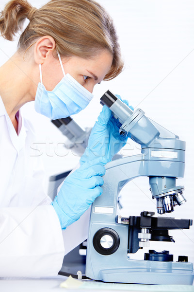 Stock photo: Woman with microscope 