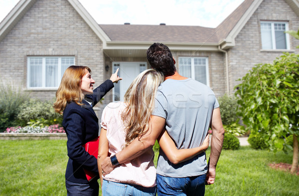 Stock photo: Real Estate agent woman with clients near new house.