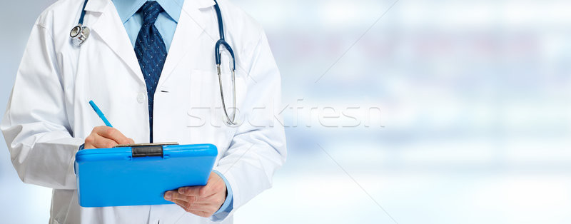 Doctor hands writing on clipboard Stock photo © Kurhan