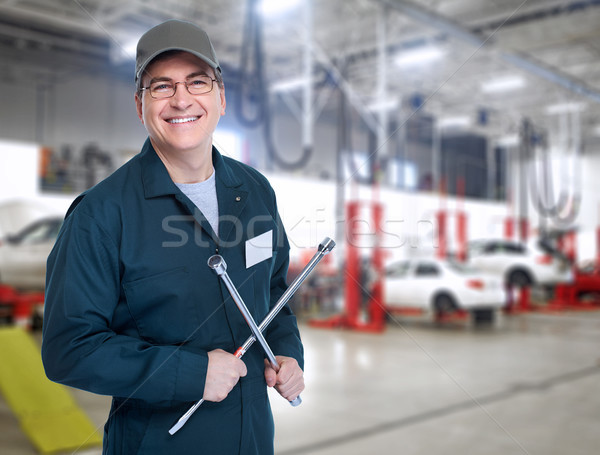 Auto mechanic with a wheel wrench. Stock photo © Kurhan