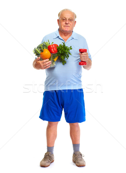 Senior man with dumbbell and vegetables. Stock photo © Kurhan