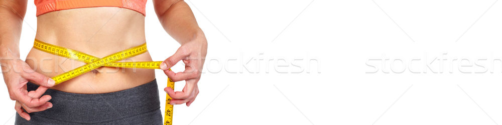 Stock photo: Woman abdomen with measuring tape over white background.