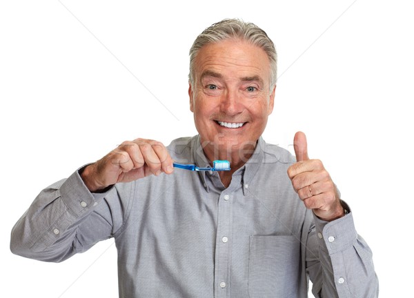 Senior man tandenborstel knap glimlachend volwassen man Stockfoto © Kurhan