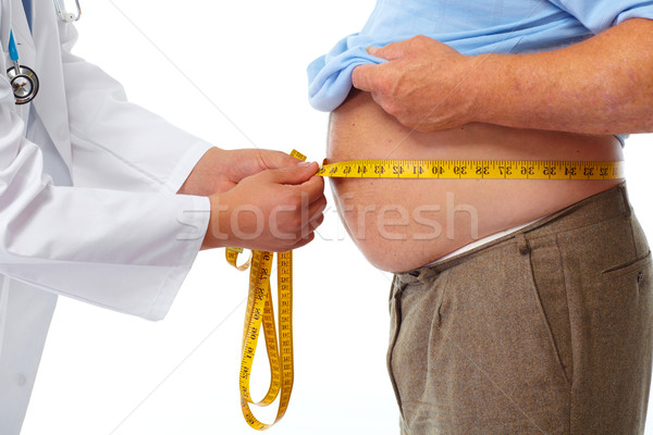 Doctor measuring obese man stomach. Stock photo © Kurhan