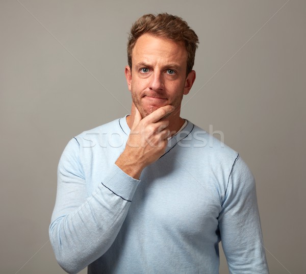 Pensando homem caucasiano retrato cinza parede Foto stock © Kurhan