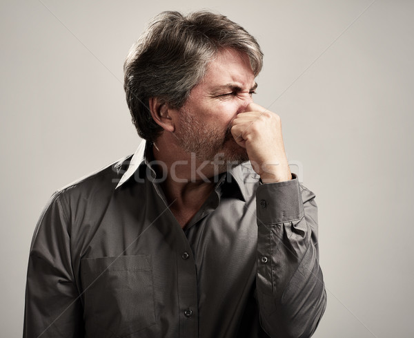 Man hiding his nose Stock photo © Kurhan