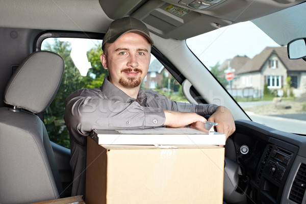 Young delivery man in the car. Stock photo © Kurhan