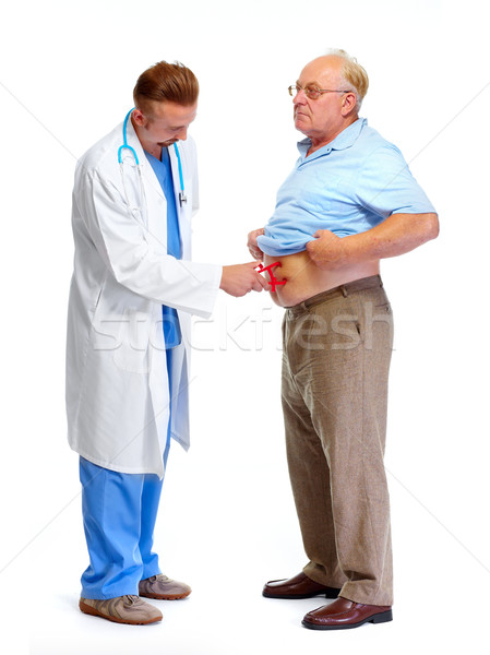 Medical doctor with body fat calipers. Stock photo © Kurhan