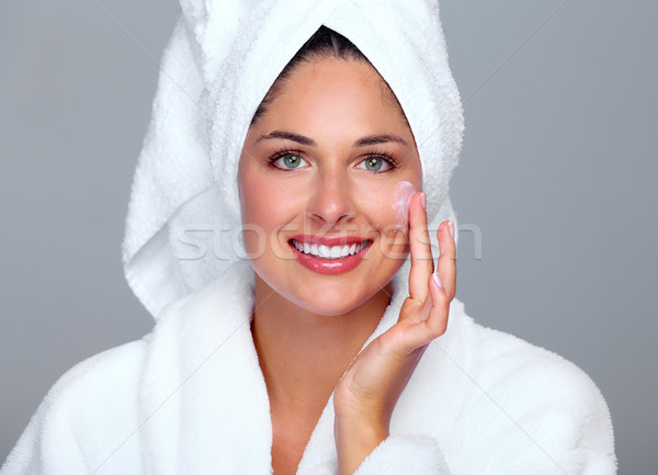 Beautiful woman face with moisturising  cream. Stock photo © Kurhan