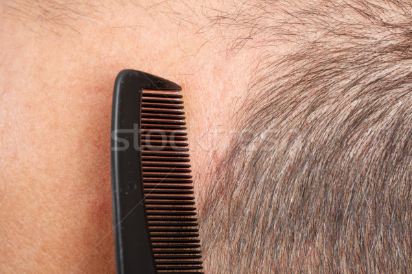 Stock photo: Man head with a comb.