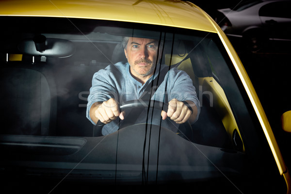 Tired man driving car at night. Stock photo © Kurhan