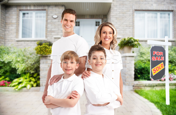 Happy family near new house. Stock photo © Kurhan