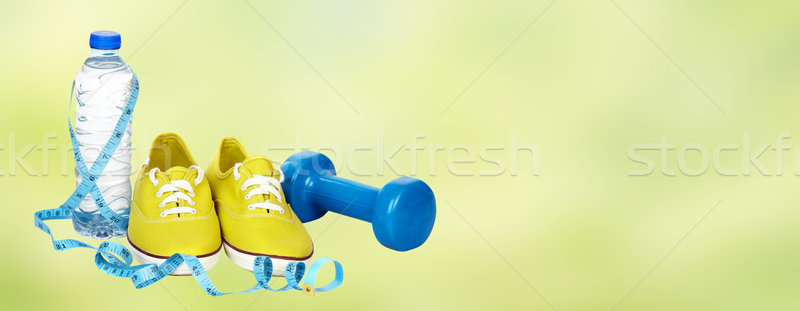 Running shoes and dumbbell. Stock photo © Kurhan