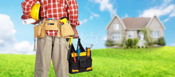 Hand of handyman with a tool bag. Stock photo © Kurhan