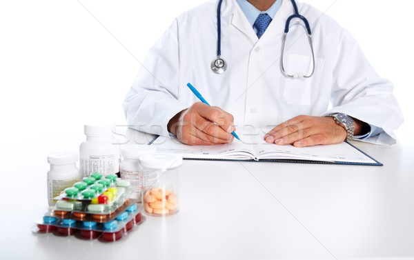 Doctor writing medical prescription. Stock photo © Kurhan
