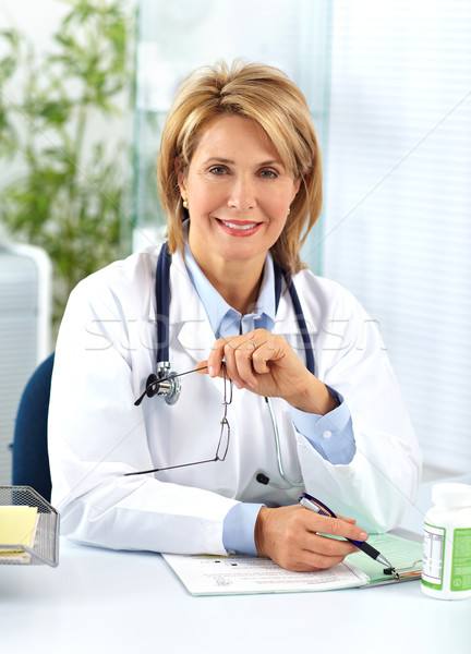 Mature doctor woman with pills. Stock photo © Kurhan