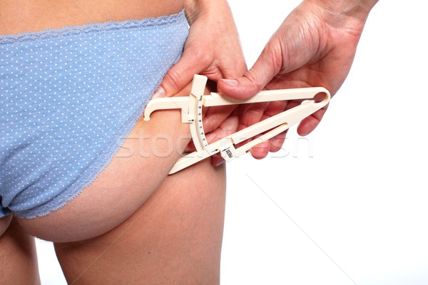 Woman measuring body fat. Stock photo © Kurhan