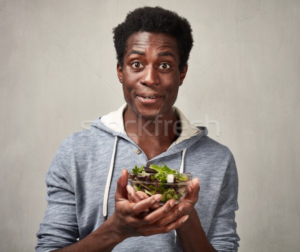 Black man with salad Stock photo © Kurhan