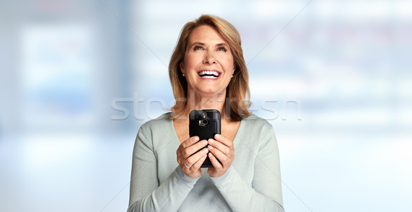 Stock photo: happy senior lady with smartphone
