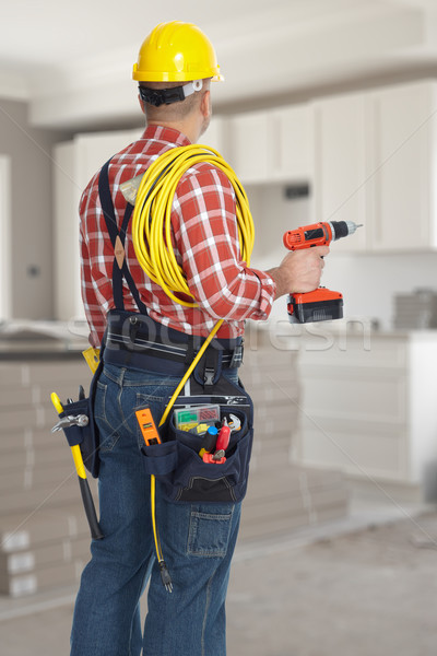 Electrician man with drill and wire cable. Stock photo © Kurhan