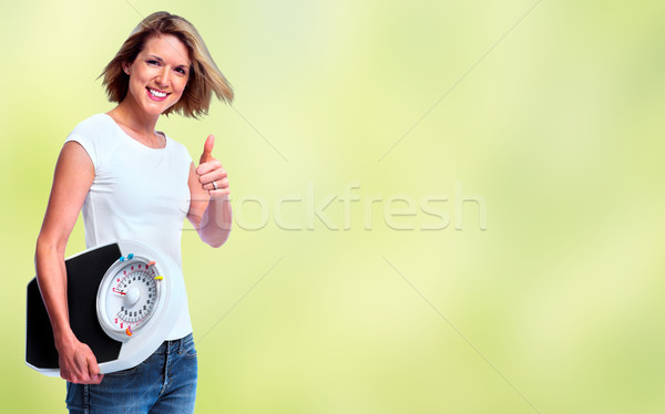 Woman with scales over green background. Stock photo © Kurhan