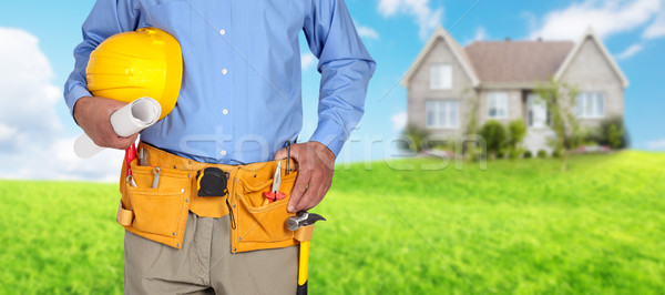 Construction worker with helmet and tool belt. Stock photo © Kurhan