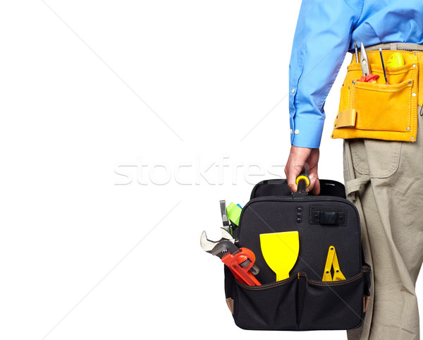 Hand of handyman with a tool bag. Stock photo © Kurhan