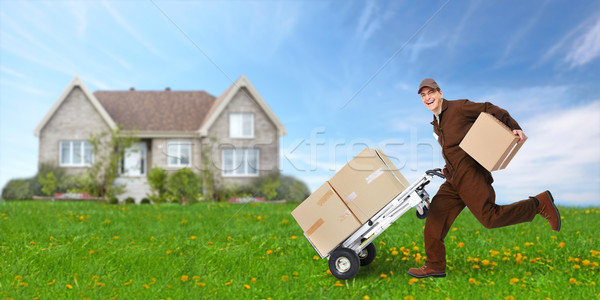 Delivery man with box running Stock photo © Kurhan