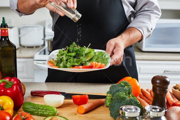 Chef man cooking in the kitchen. Stock photo © Kurhan