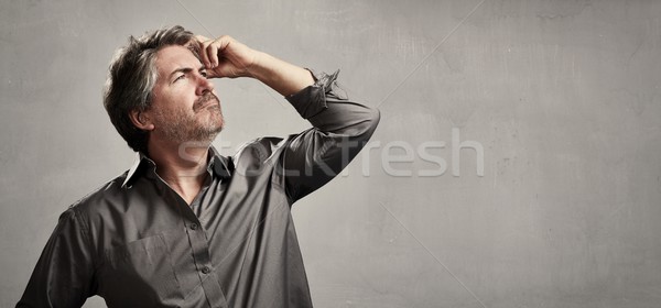 Pensando homem caucasiano retrato cinza parede Foto stock © Kurhan