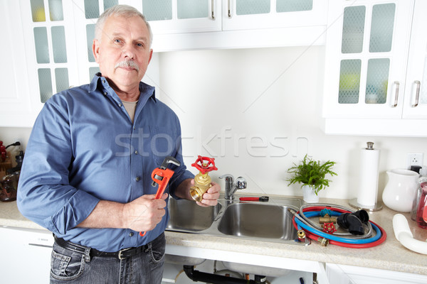 Plumber in kitchen with a wrench. Stock photo © Kurhan
