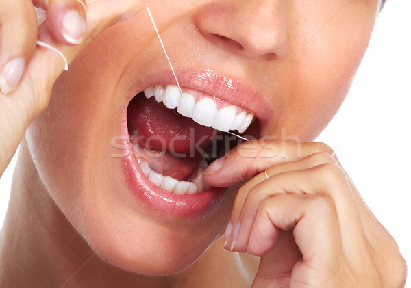 Nő fogak fogselyem fogászat egészségügy lány Stock fotó © Kurhan