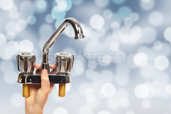 Hand of plumber with a water tap. Stock photo © Kurhan