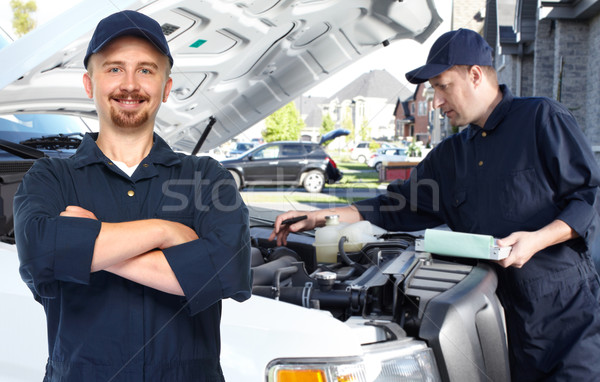 Smiling car mechanic in auto repair service. Stock photo © Kurhan