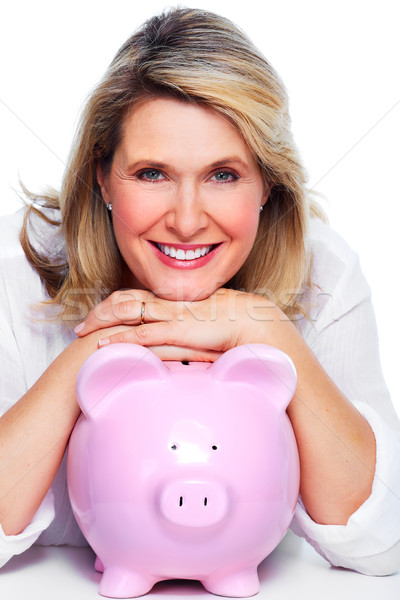 Stock photo: Elderly woman with piggy bank.