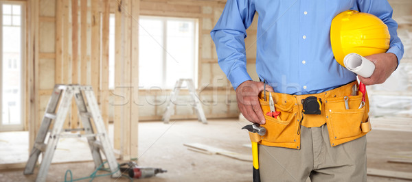 Construction worker with helmet and tool belt. Stock photo © Kurhan