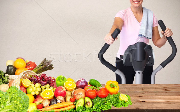 Woman with elliptical trainer Stock photo © Kurhan