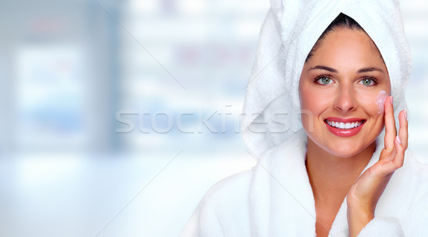 Beautiful woman face with moisturising  cream. Stock photo © Kurhan