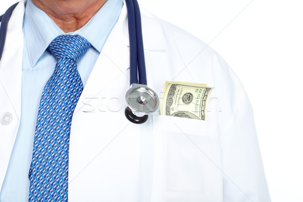 Hands of medical doctor with money. Stock photo © Kurhan