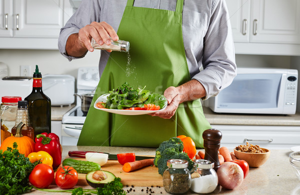 Chef man cooking in the kitchen. Stock photo © Kurhan