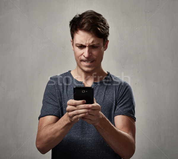 Angry man with cell phone. Stock photo © Kurhan