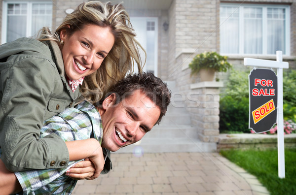 Happy couple near new house. Stock photo © Kurhan