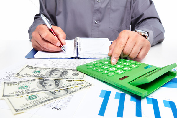 Hands of businessman with calculator. Stock photo © Kurhan