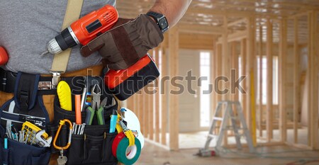 Hand of handyman with a tool bag. Stock photo © Kurhan