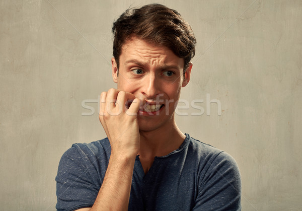 Ansioso homem nervoso retrato cinza parede Foto stock © Kurhan