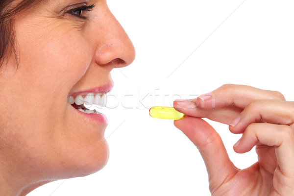 Woman with pill. Stock photo © Kurhan