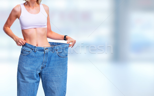 Frau tragen groß pants Abdomen blau Stock foto © Kurhan