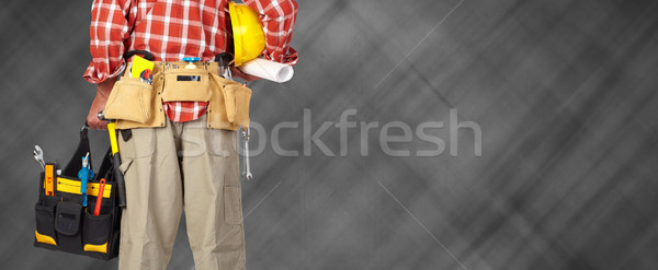 Hand of handyman with a tool bag. Stock photo © Kurhan